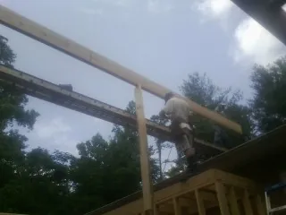 Carpenter setting a ridge beam over a new addition frame — Ice Dam Removal by Roofing Brothers in Walla Walla