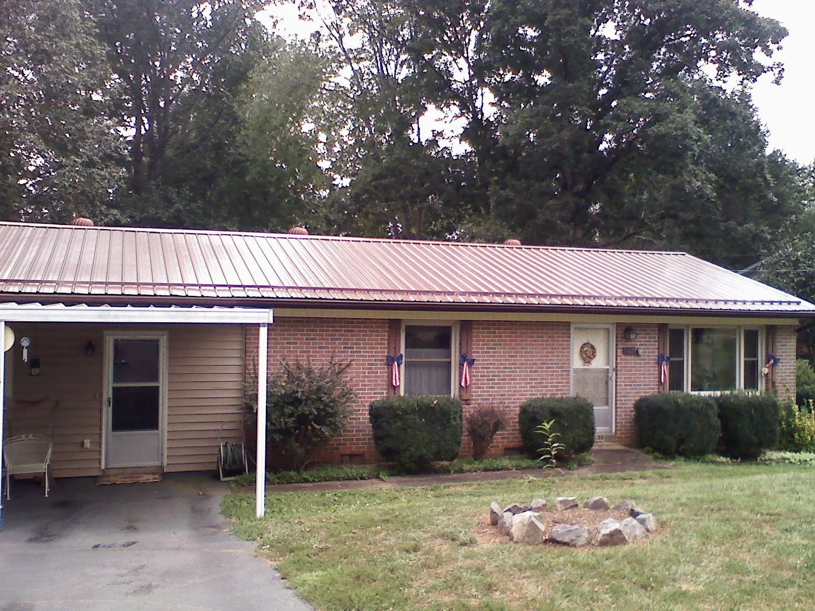 Bronze metal roof and carport on a brick ranch home — Roof Repair work by our crew in Walla Walla